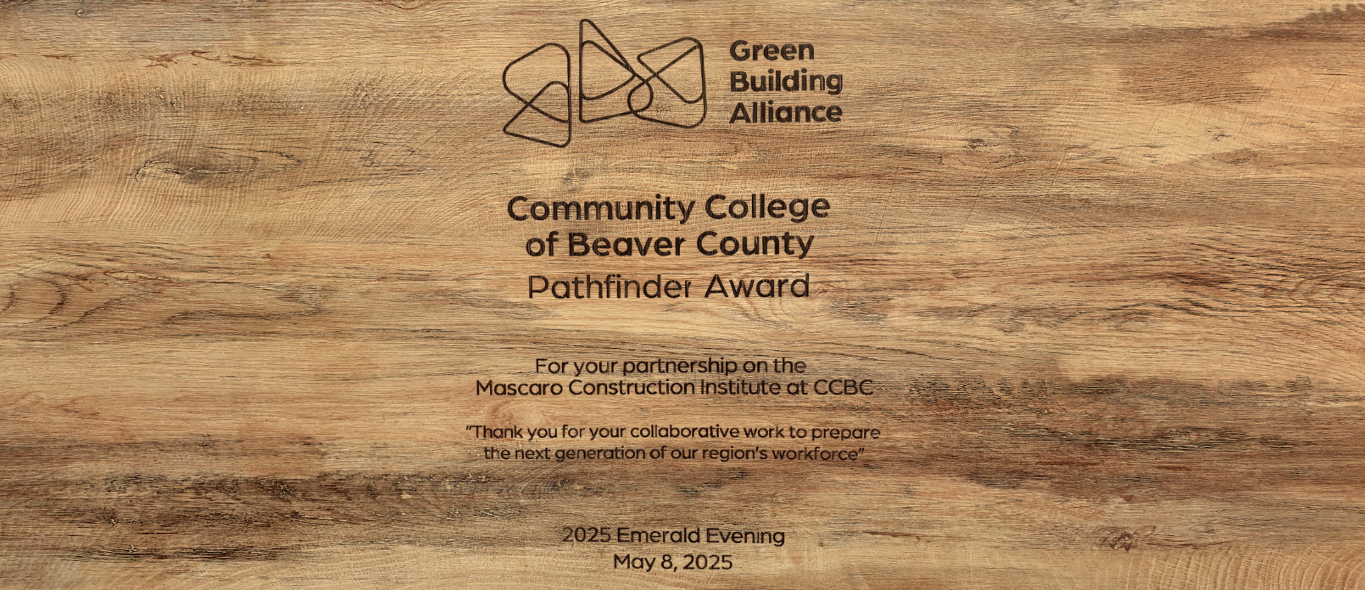 Wooden background of Green Building Alliance - Community College of Beaver County Pathfinder Award - For your parbership on the Mascaro Construction Institute at CCBC - Thank you for your collabortive work to prepare the next generation of our region's workforce - 2025 Emerald Evening May 8, 2025